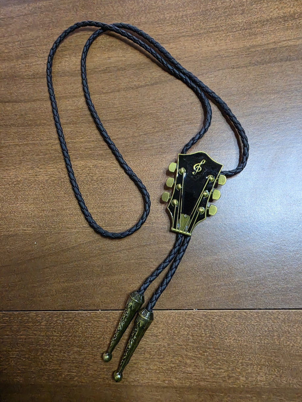 Source Unknown Black Bolo Tie with Gold Guitar Head Accent